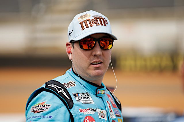 Kyle Busch wearing sunglasses and m&m's crunchy cookie hat at the 2022 NASCAR Cup bristol dirt race, NKP
