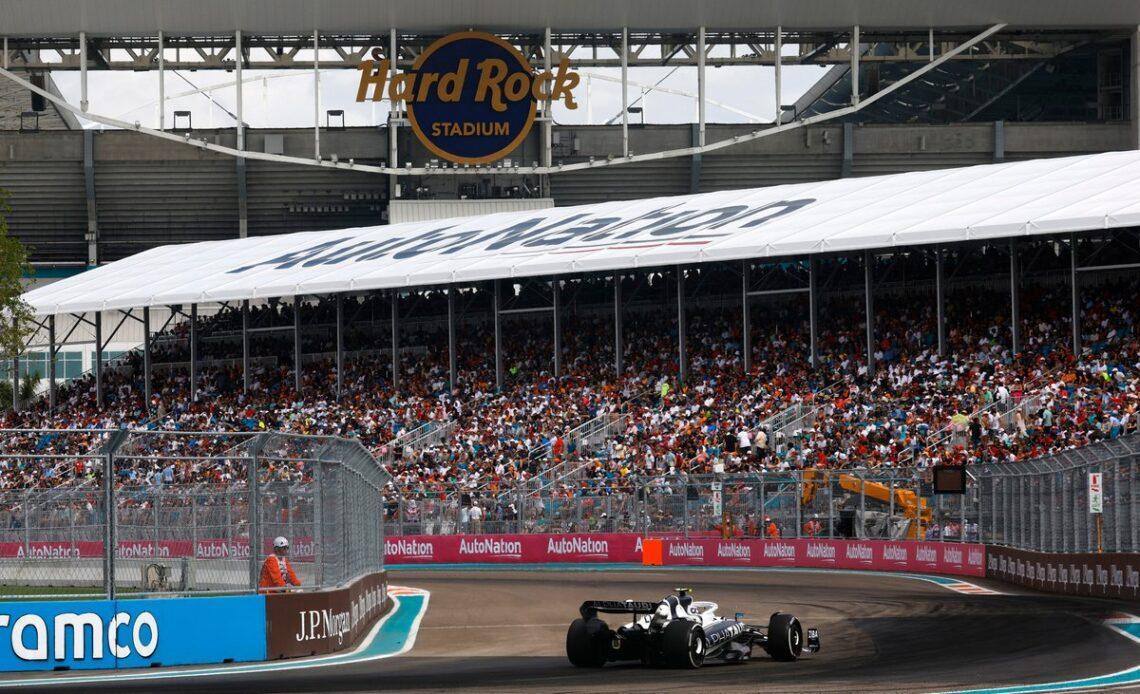 Tsunoda passes under the shadow of the Hard Rock Stadium, which welcomed celebrities in their droves to sample F1 first-hand