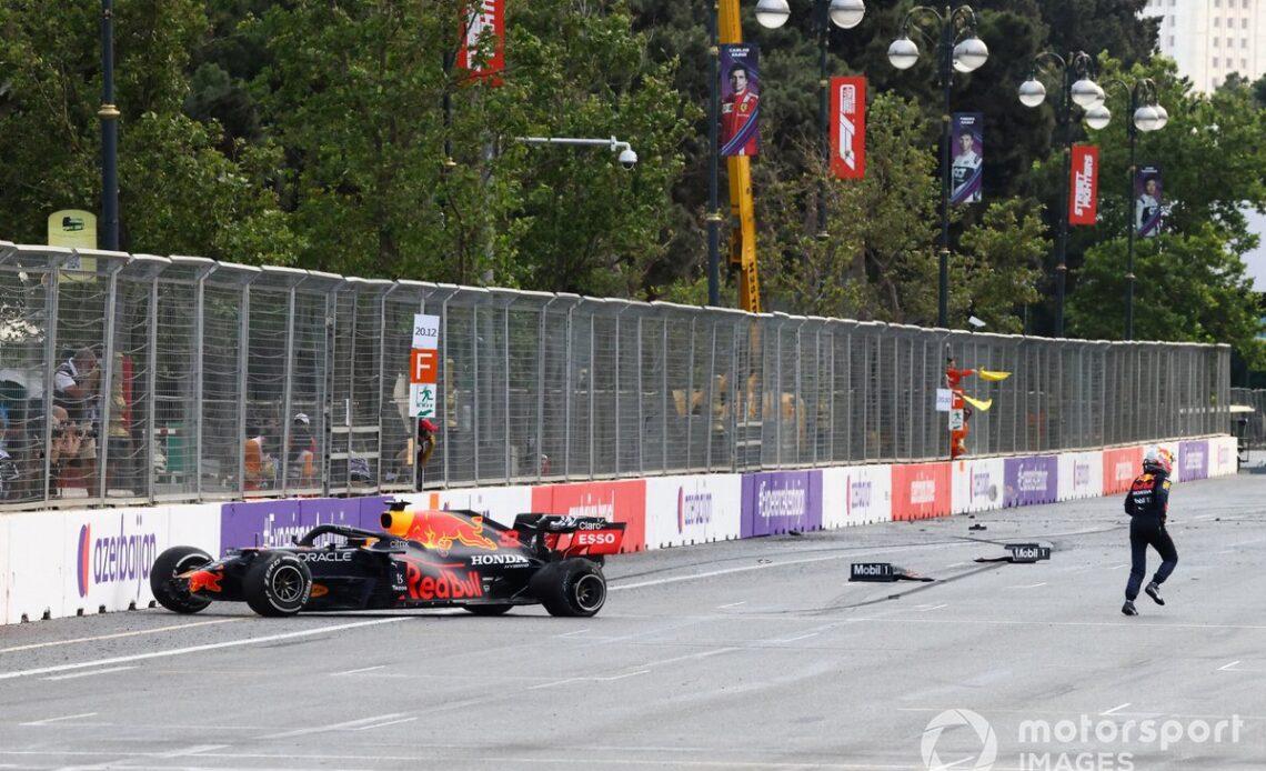 Max Verstappen, Red Bull Racing, climbs out of his car after crashing out from the lead