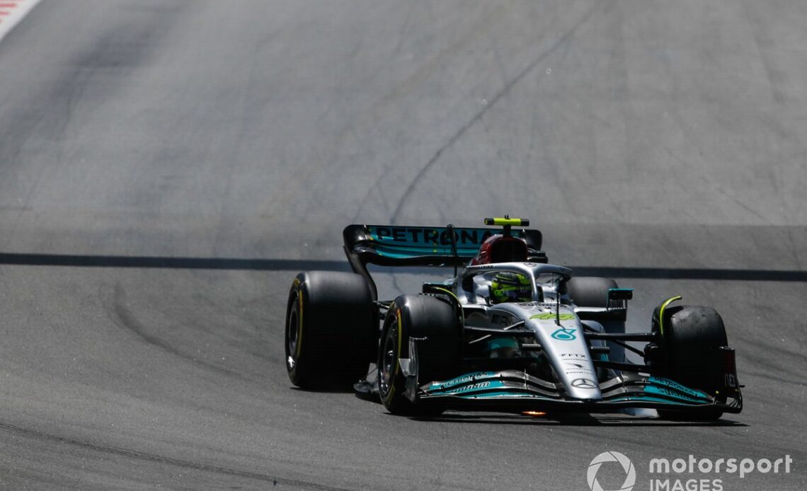 Lewis Hamilton, Mercedes W13, heads to the pits with damage after contact on the opening lap