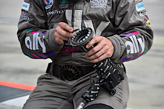 #48: Alex Bowman, Hendrick Motorsports, Ally Throwback Chevrolet Camaro tire changer with speed gun. nkp