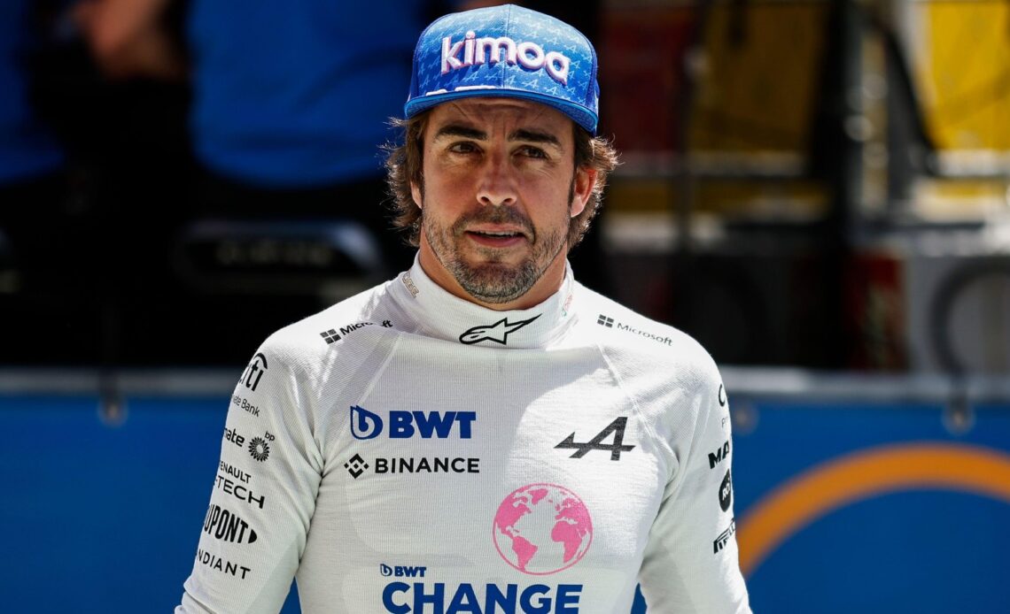 Fernando Alonso looks up whilst walking down the track. Barcelona, May 2022.