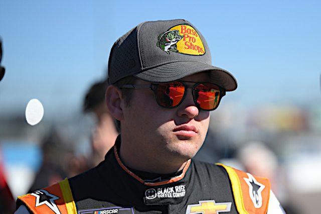 Noah Gragson in Bass Pro Shops grey hat and sunglasses, NKP
