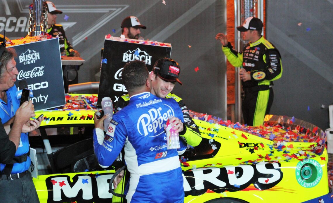 Ryan Blaney and Bubba Wallace hug after Blaney wins the 2022 NASCAR All-Star Race. (Photo: Rick Lunkenheimer)