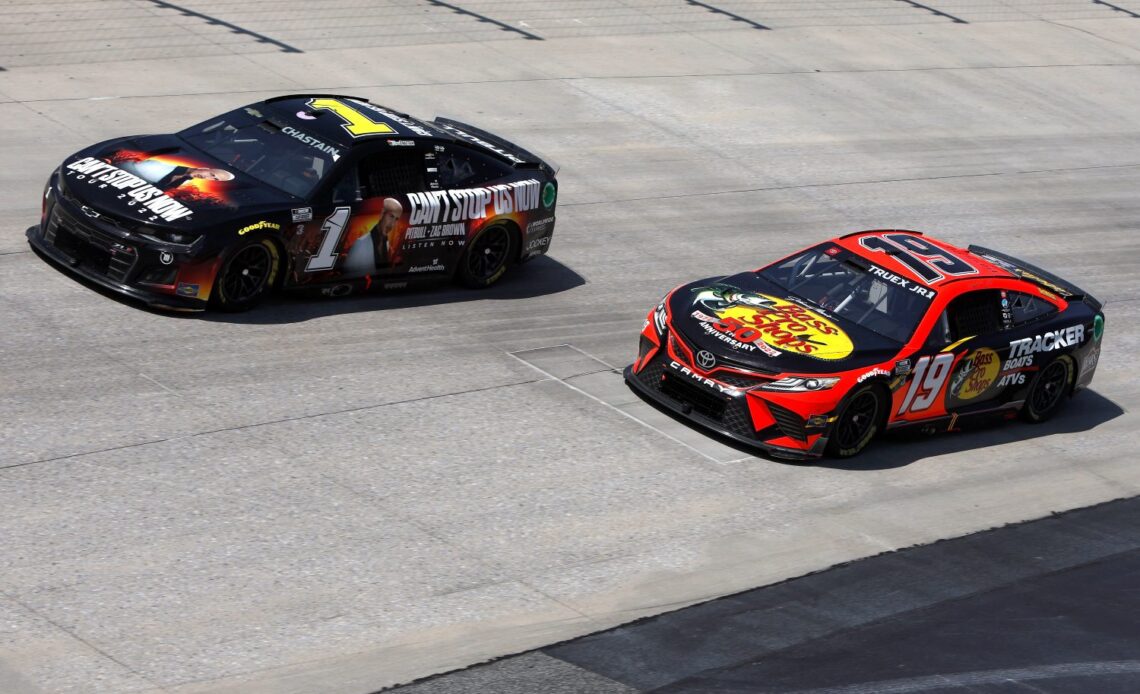 Ross Chastain, driver of the #1 Pitbull Tour 2022 Chevrolet, and Martin Truex Jr., driver of the #19 Bass Pro Shops Toyota, race during the NASCAR Cup Series DuraMAX Drydene 400 presented by RelaDyne at Dover Motor Speedway on May 02, 2022 in Dover, Delaware. (Photo by Sean Gardner/Getty Images)