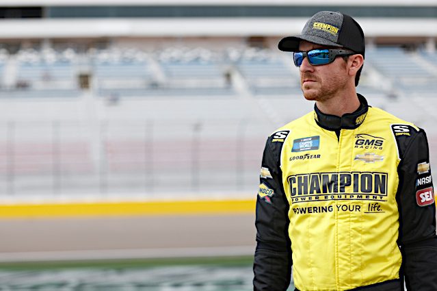 2022 Las Vegas Trucks Grant Enfinger wearing sunglasses and a hat and a yellow firesuit, NKP