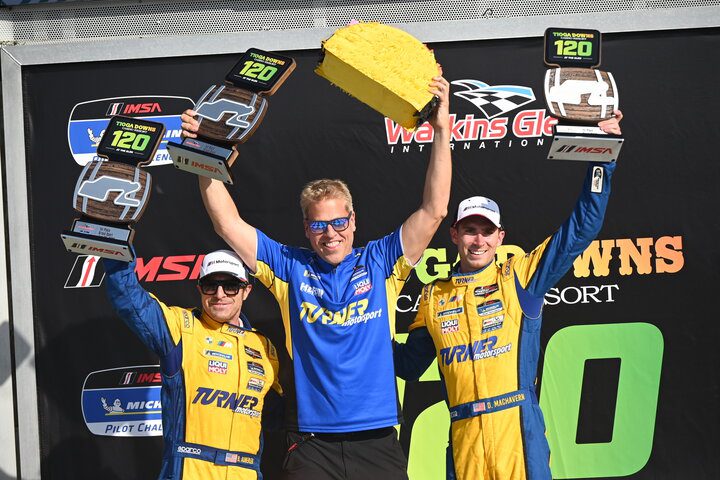 Bill Auberlen and Dillon Machavern are joined by car owner Will Turner on the podium after winning the Tioga Downs Casino Resort 120 at Watkins Glen, 6/25/2022 (Photo: Phil Allaway)