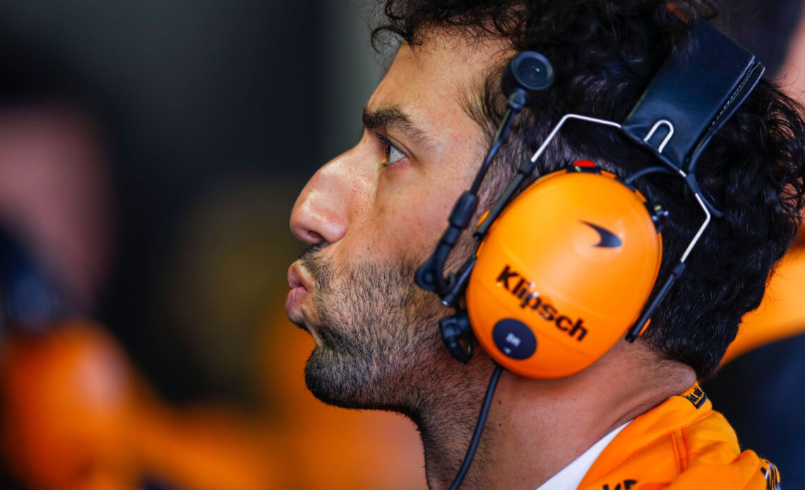 Daniel Ricciardo lips pursed as he watches the monitor. Monaco May 2022