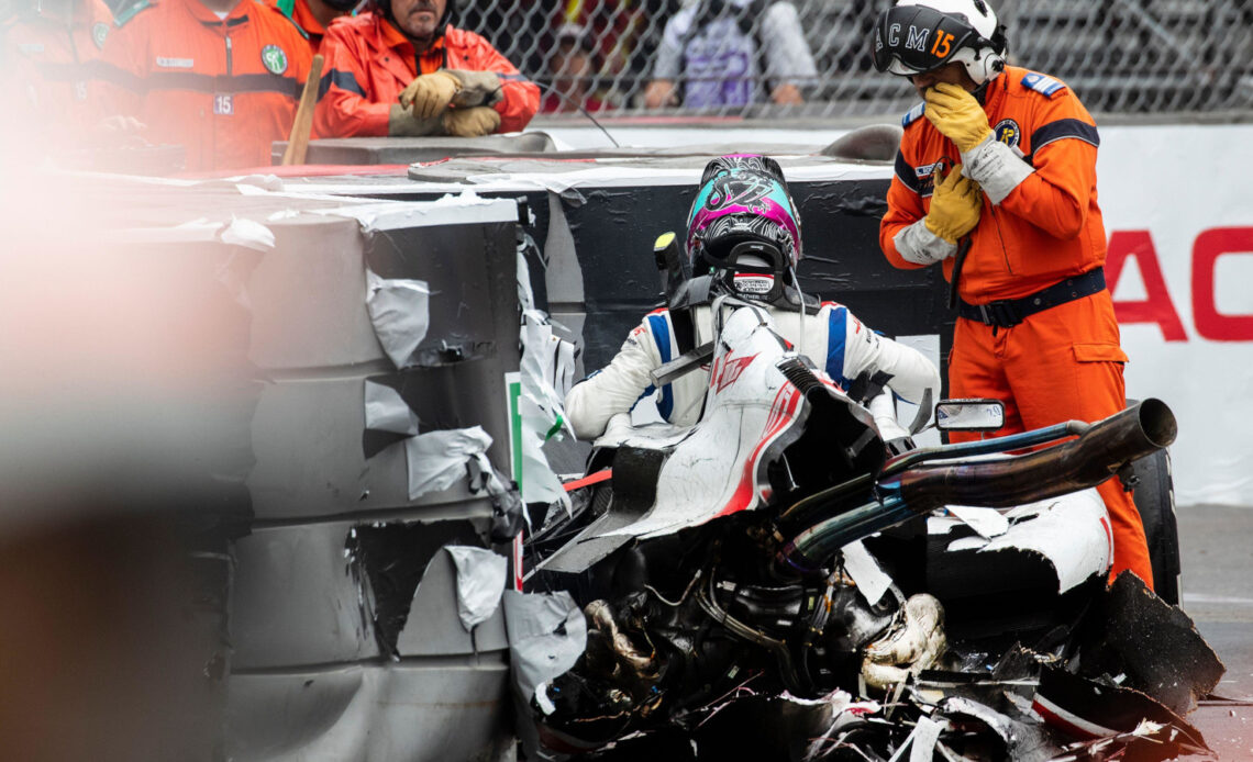 Mick Schumacher climbs out of the wreckage of his Haas VF-22. Monaco May 2022