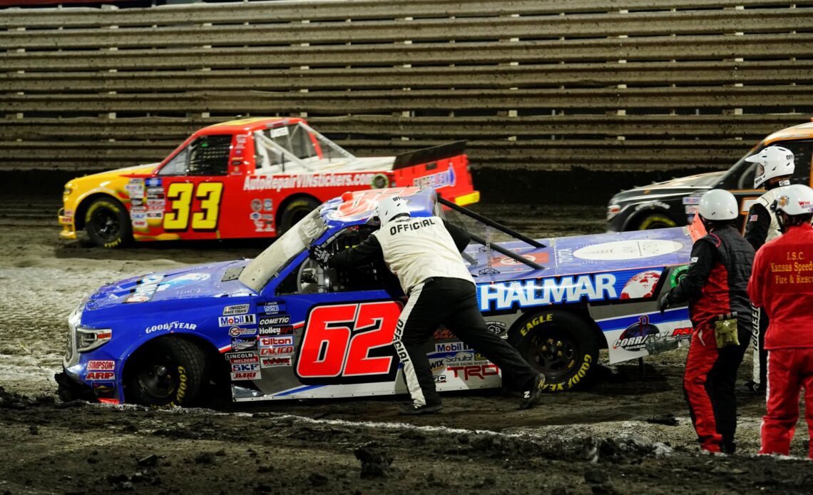 Jessica Friesen, driver of the #62 Halmar International Toyota, is helped by race crews after crashing during the NASCAR Camping World Truck Series Clean Harbors 150 at Knoxville Raceway on June 18, 2022 in Knoxville, Iowa. (Photo by Kyle Rivas/Getty Images)