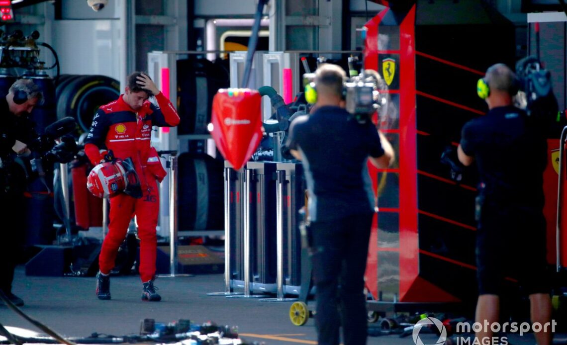 Charles Leclerc, Ferrari, walks back to his garage after retiring from the race