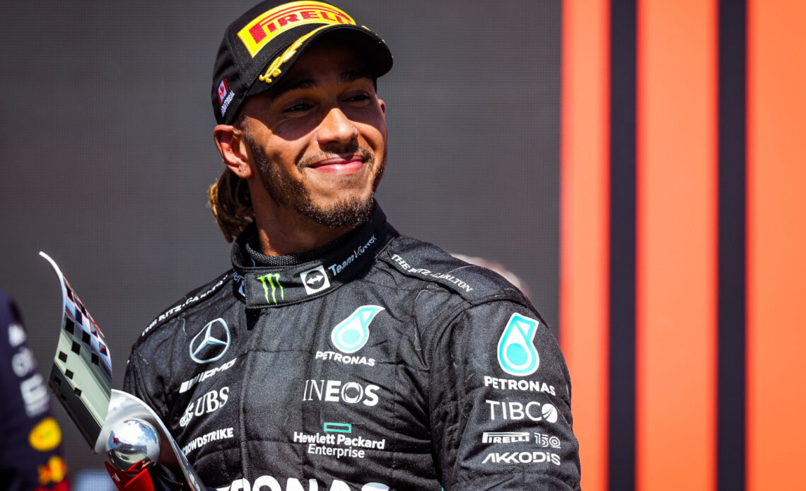 Lewis Hamilton smiling on the podium after finishing third. Montreal June 2022