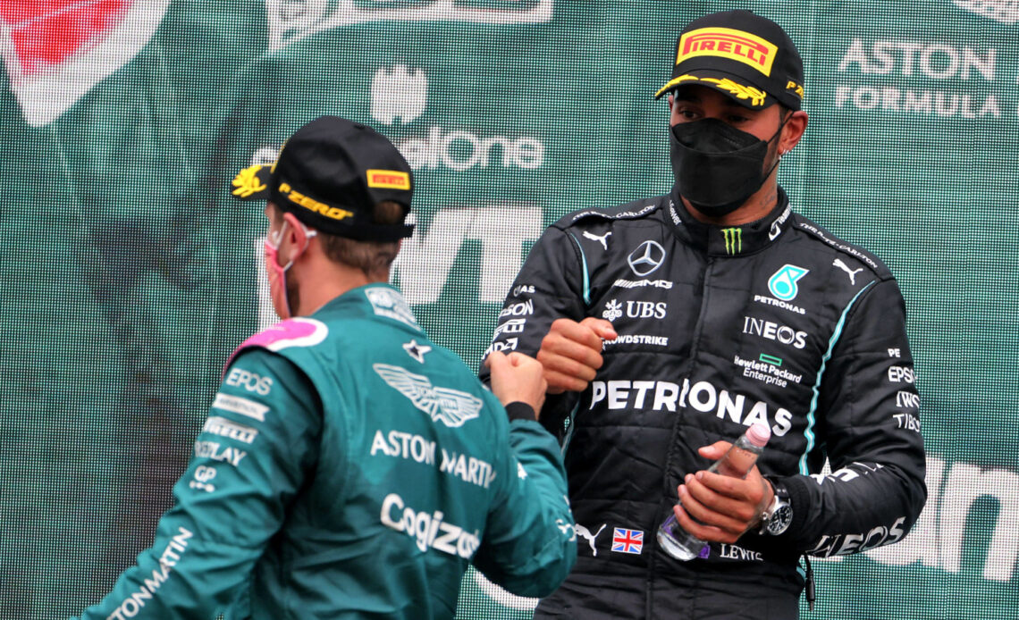 Sebastian Vettel and Lewis Hamilton fist bump on the podium. Hungary August 2021
