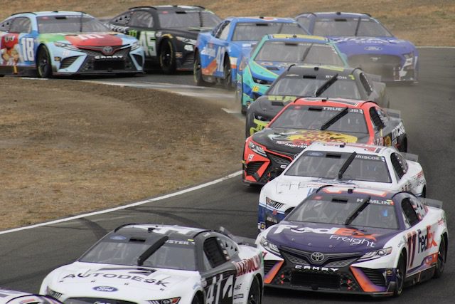 A pack of NASCAR Cup cars races at Sonoma Raceway, June 2022.