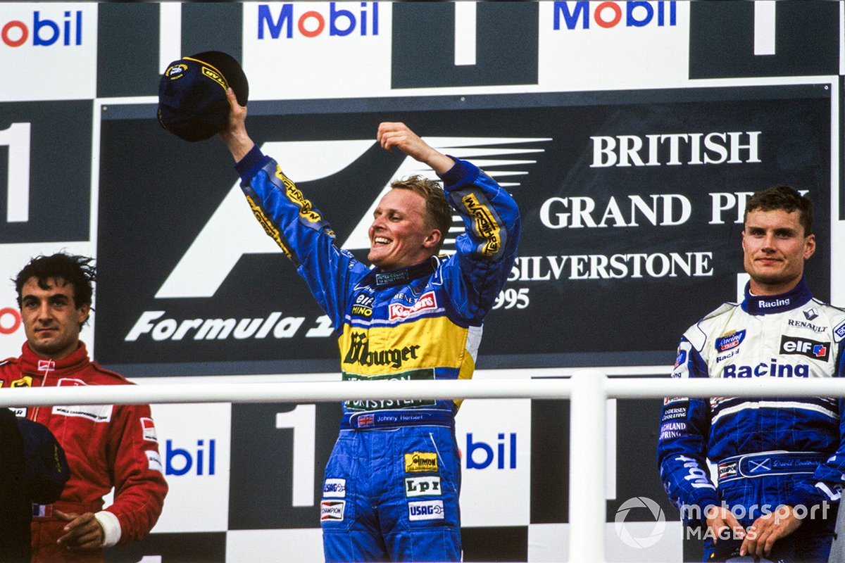 Jean Alesi, 2nd position, Johnny Herbert, 1st position, and David Coulthard, 3rd position, celebrate on the podium