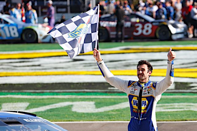 Chase Elliott holds checkered flag after winning the NASCAR Cup Series race at Atlanta Motor Speedway, NKP