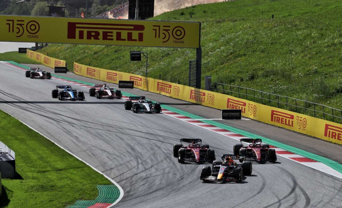 Carlos Sainz and Charles Leclerc, Ferrari, chase Max Verstappen, Red Bull. Austria, July 2022.