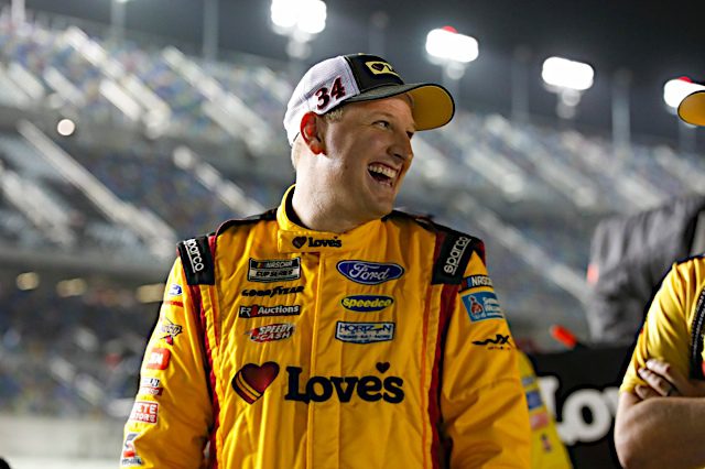 Michael McDowell smiles while walking down pit road at Daytona International Speedway. (Photo: NKP)