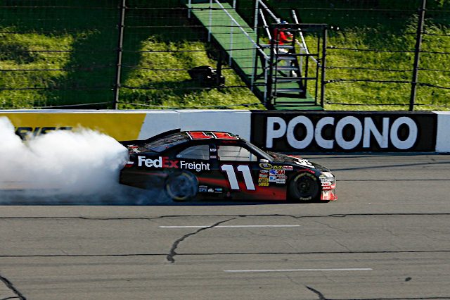Denny Hamlin does a burnout in the 2010 NASCAR Cup Series race at Pocono Raceway, NKP