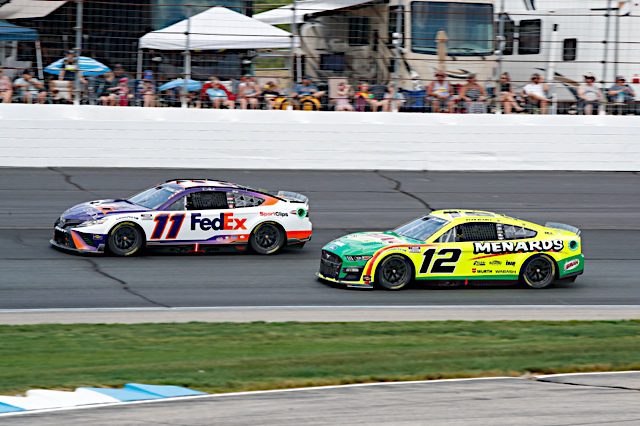 NASCAR drivers Denny Hamlin and Ryan Blaney race at New Hampshire Motor Speedway, July 2022. Photo: NKP