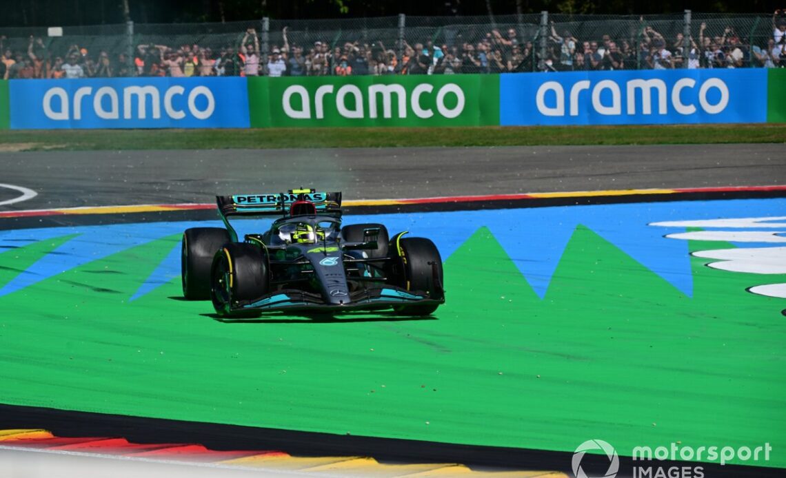 Lewis Hamilton, Mercedes W13, cuts across a corner after contact with Fernando Alonso, Alpine A522