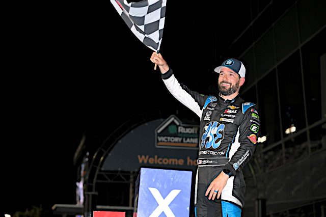 Jeremy Clements waving checkered flag in victory lane at Daytona, NKP