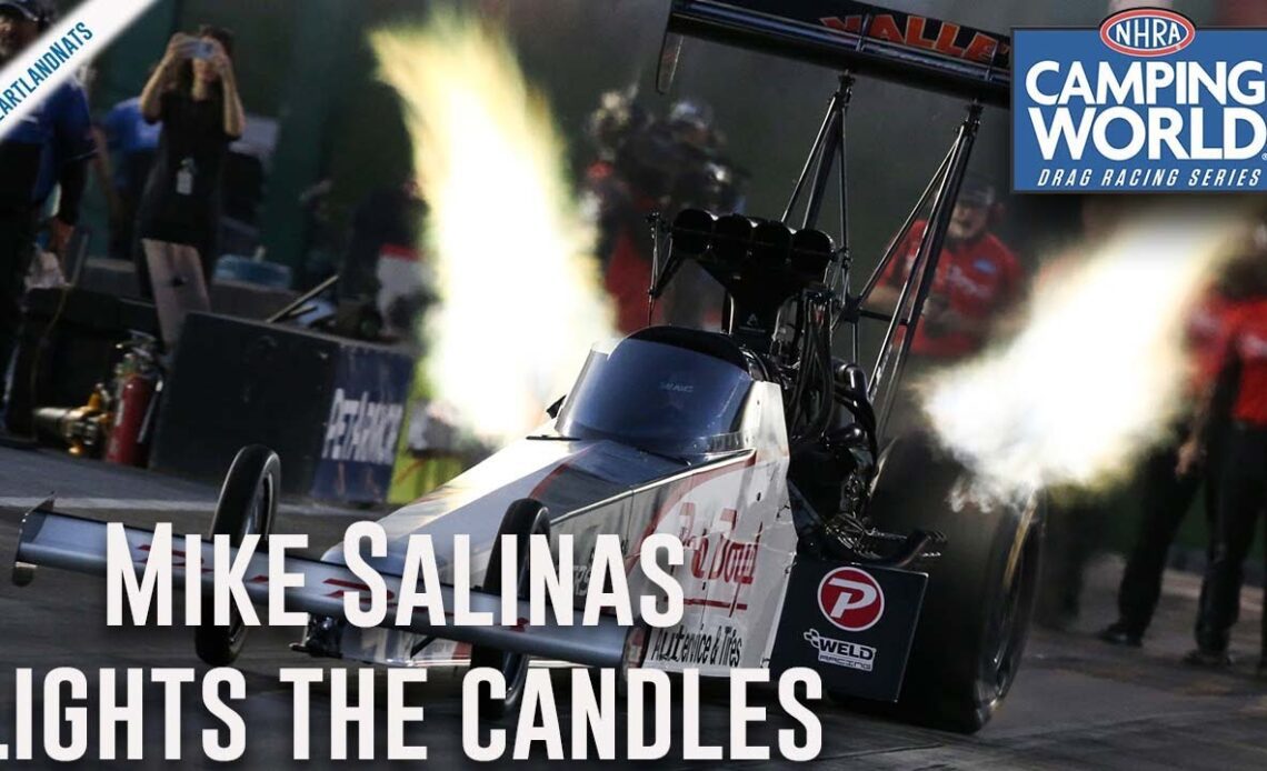 Mike Salinas lights the candles Friday in Topeka