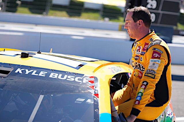 NASCAR Cup Series driver Kyle Busch emerges from his car at Pocono Raceway in July 2022. (Photo: NKP)