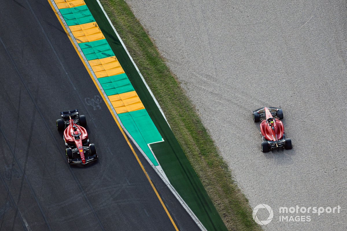 Charles Leclerc, Ferrari F1-75, passes the beached car of Carlos Sainz Jr., Ferrari F1-75