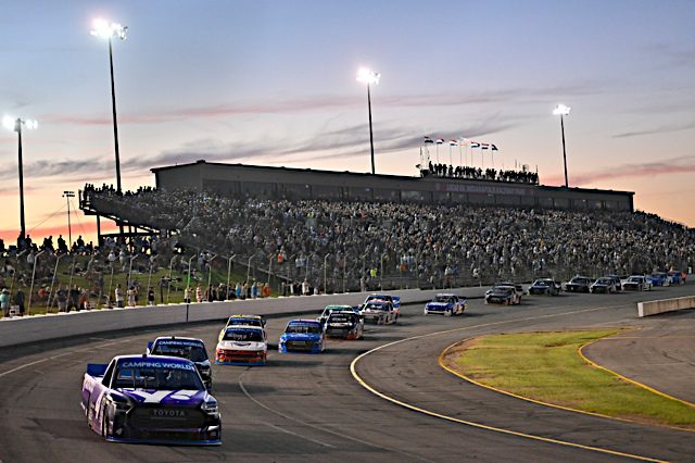 John Hunter Nemechek racing in front of the pack at the Lucas Oil Indianapolis Raceway Park as the sun sets. NKP