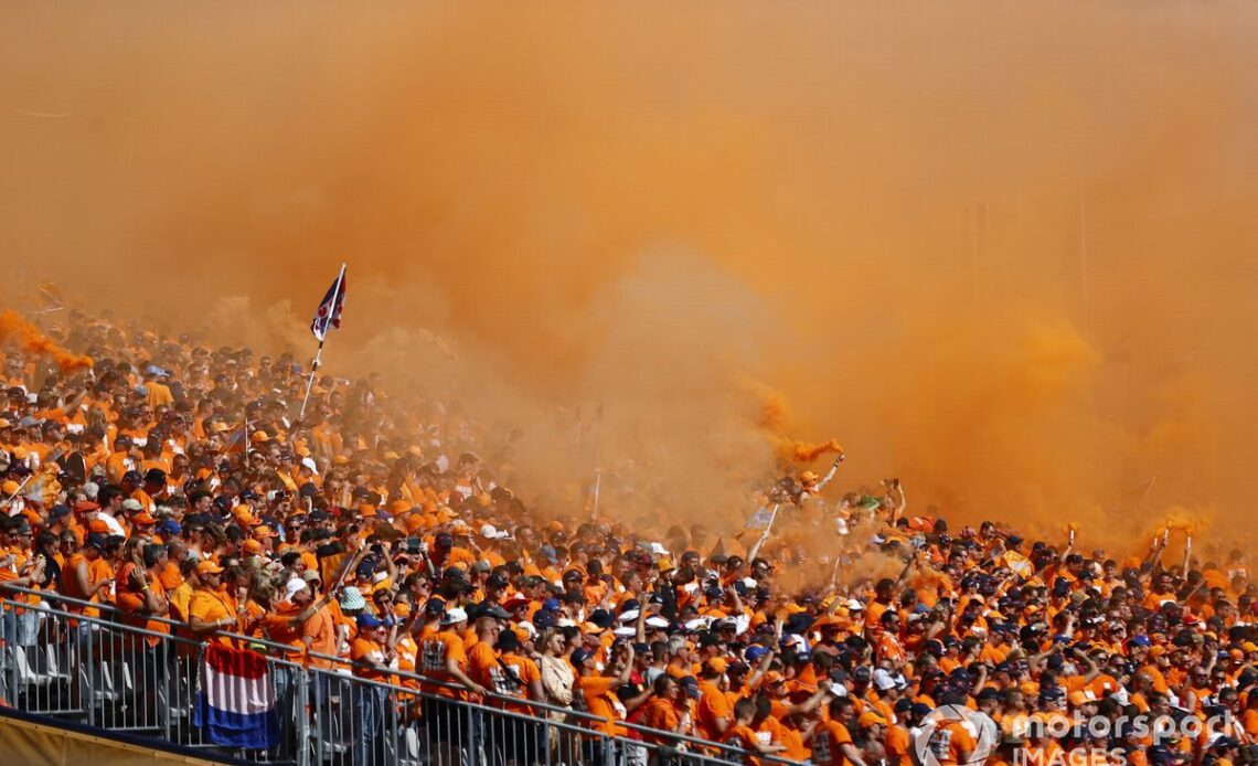 Dutch fans turn the air orange with smoke flares