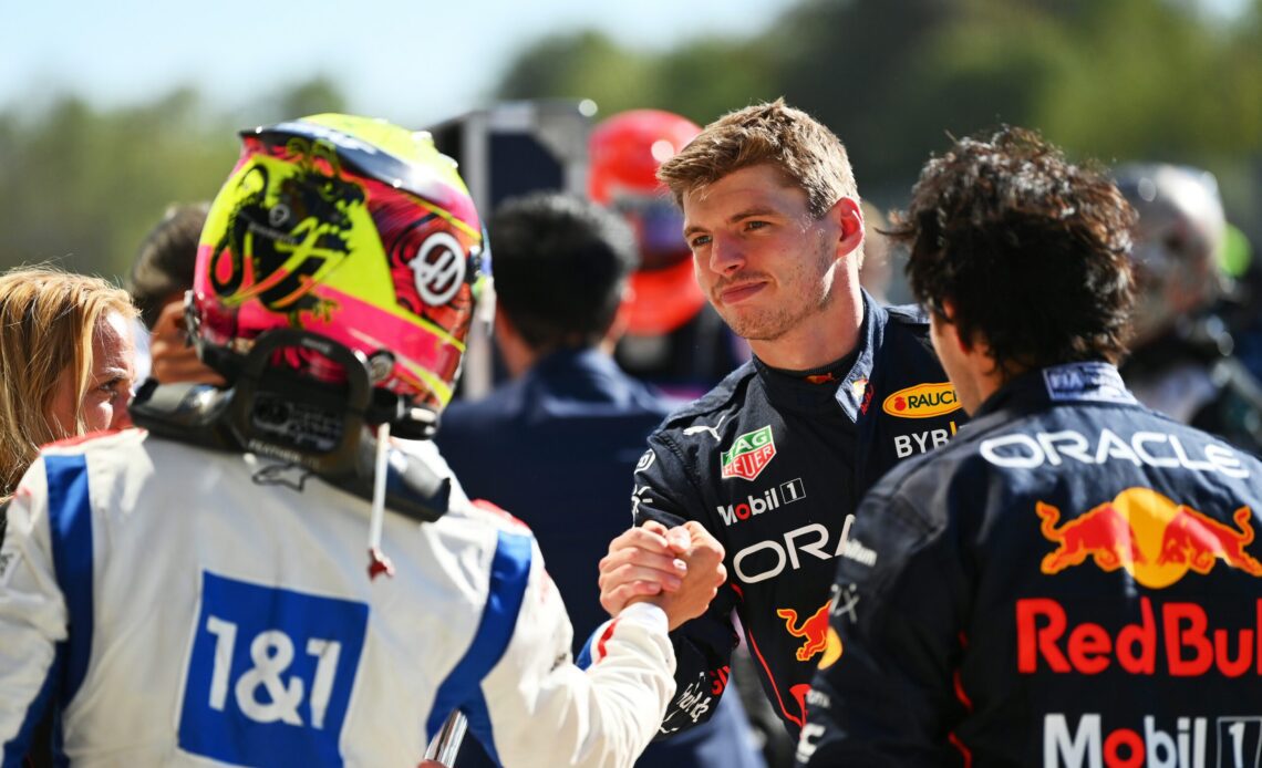 MONZA, ITALY - SEPTEMBER 11: Race winner Max Verstappen of the Netherlands and Oracle Red Bull Racing is congratulated by sixteenth placed Kevin Magnussen of Denmark and Haas F1 in parc ferme during the F1 Grand Prix of Italy at Autodromo Nazionale Monza on September 11, 2022 in Monza, Italy. (Photo by Dan Mullan/Getty Images via Red Bull Content Pool)