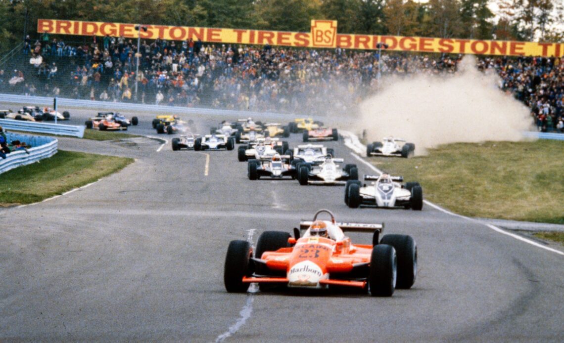 Giacomelli escapes in the lead as behind Jones is turfed onto the grass. But by the end of the F1's final race at Watkins Glen it would be the Williams man on the top step of the podium