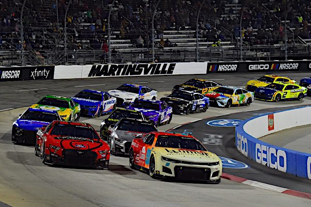 Chase Elliott leads a pack of NASCAR racecars at Martinsville Speedway, April 2022. Photo: NKP