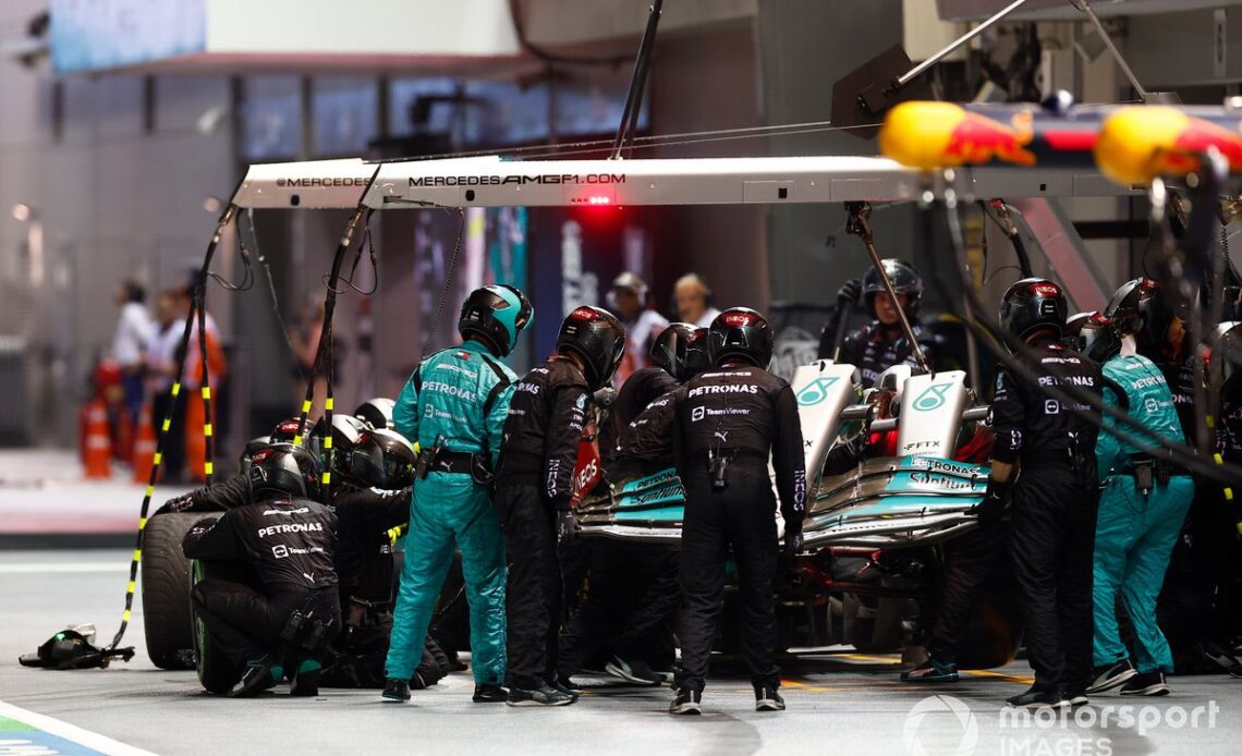 The Mercedes pit crew replace a front wing on the car of Lewis Hamilton, Mercedes W13