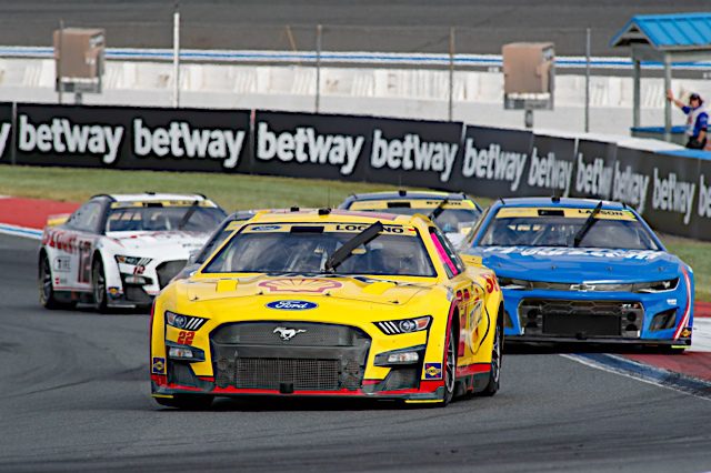 Joey Logano leads a pack of NASCAR race cars at Charlotte Motor Speedway, October 2022