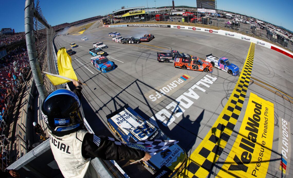 Matt DiBenedetto, driver of the #25 Rackley Roofing Chevrolet, takes the checkered flag under caution over Bret Holmes, driver of the #32 Golden Eagle Syrup Chevrolet, to win the NASCAR Camping World Truck Series Chevy Silverado 250 at Talladega Superspeedway on October 01, 2022 in Talladega, Alabama. (Photo by Chris Graythen/Getty Images)