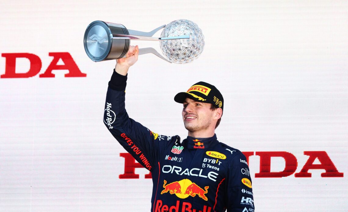 SUZUKA, JAPAN - OCTOBER 09: Race winner and 2022 F1 World Drivers Champion Max Verstappen of Netherlands and Oracle Red Bull Racing Max Verstappen of the Netherlands and Oracle Red Bull Racing celebrates on the podium during the F1 Grand Prix of Japan at Suzuka International Racing Course on October 09, 2022 in Suzuka, Japan.