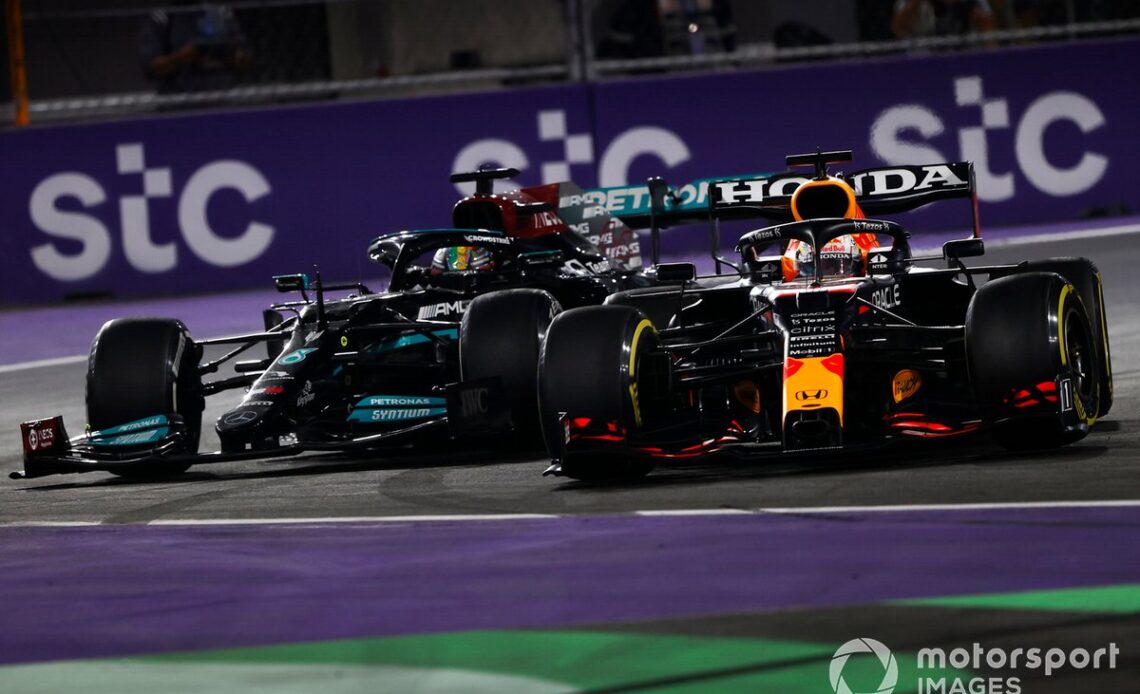 Max Verstappen, Red Bull Racing RB16B, and Lewis Hamilton, Mercedes W12, make contact as they battle for the lead