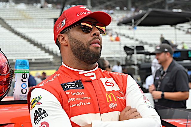 Bubba Wallace stands on pit lane at Indianapolis Motor Speedway. (Photo: NKP)