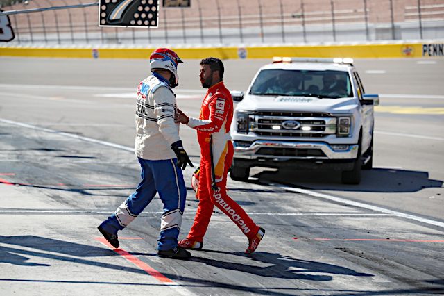 Bubba Wallace is restrained by a NASCAR official after a confrontation with Kyle Larson at Las Vegas Motor Speedway. (Photo: NKP)