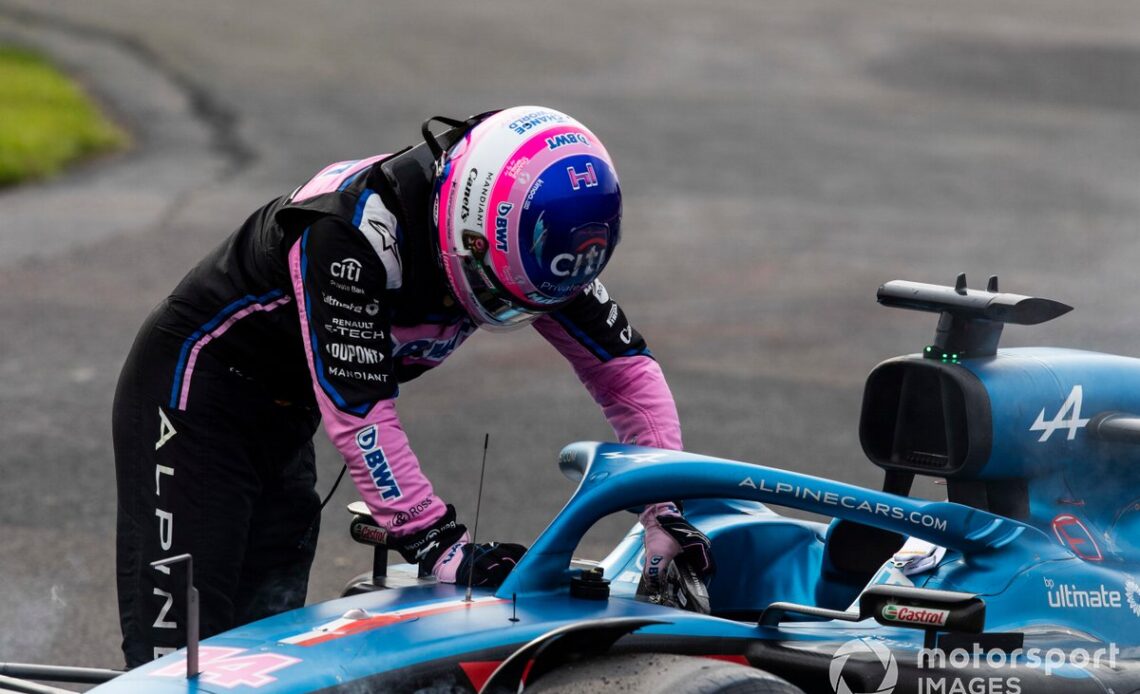 Fernando Alonso, Alpine F1 Team, climbs out of his car after retiring from the race