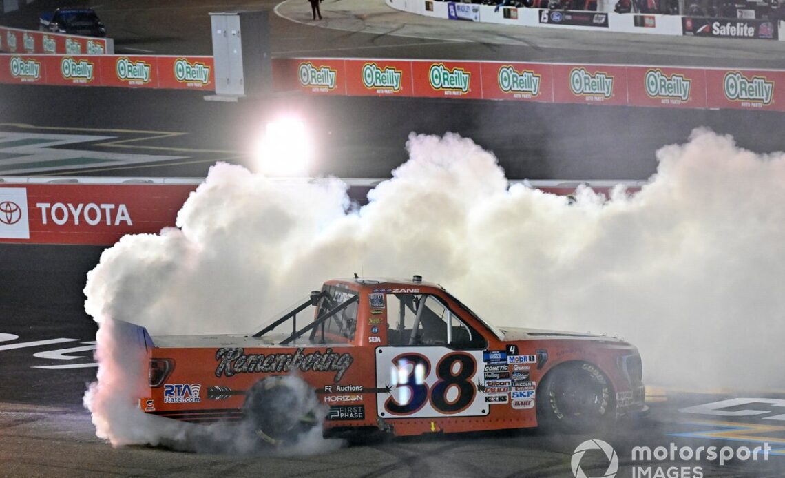 Zane Smith, Front Row Motorsports, Michael Roberts Construction Ford F-150 celebrates his victory and championship