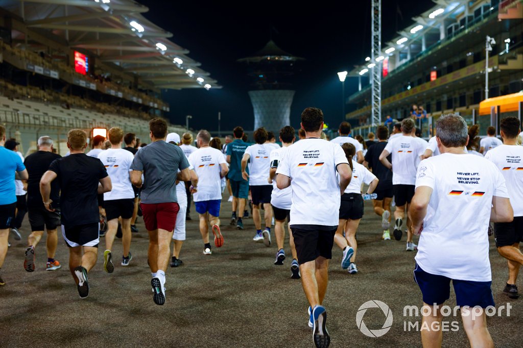 Sebastian Vettel, Aston Martin, is joined on a run around the circuit by team members and well wishers as part of his farewell at his final Grand Prix