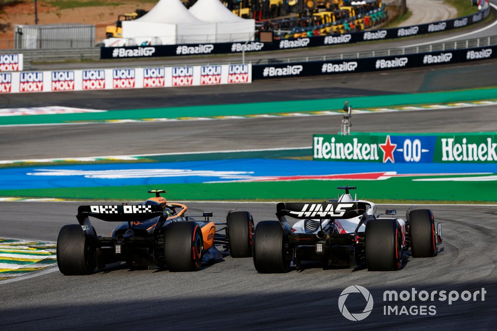 Lando Norris, McLaren MCL36, battles with Kevin Magnussen, Haas VF-22