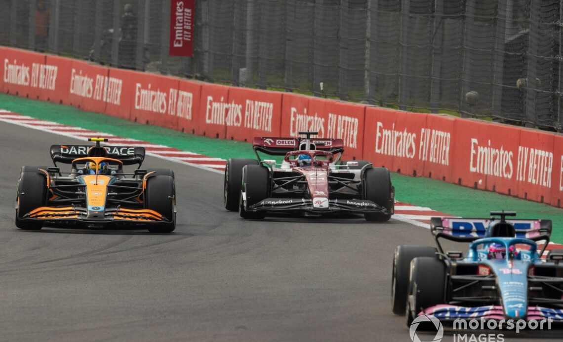 Fernando Alonso, Alpine A522, leads Lando Norris, McLaren MCL36, and Valtteri Bottas, Alfa Romeo C42