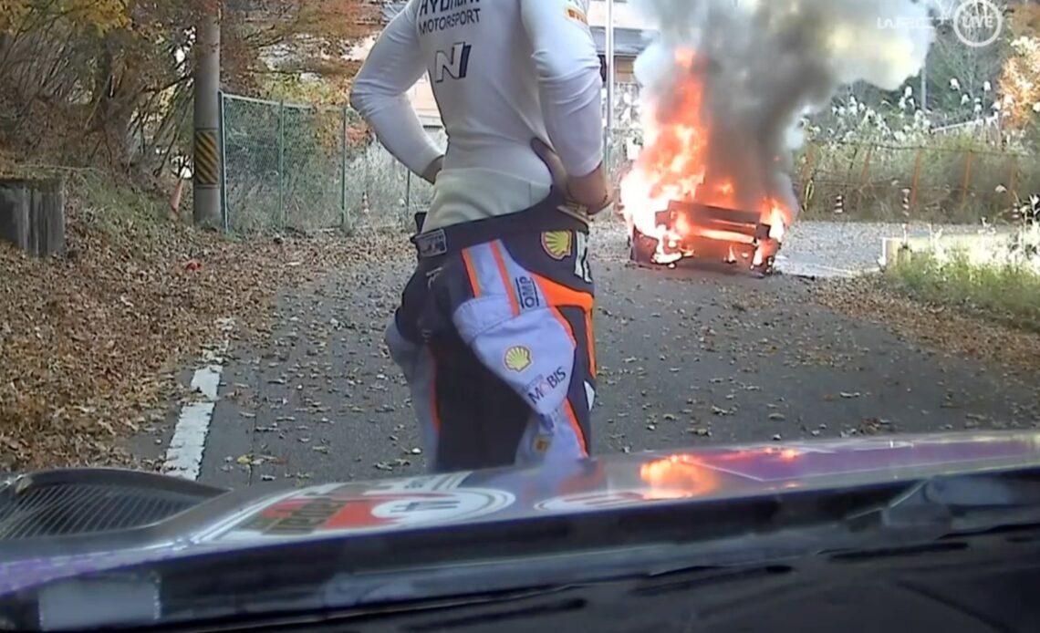 Dani Sordo stands in front of Hyundai which caught fire on Stage 2