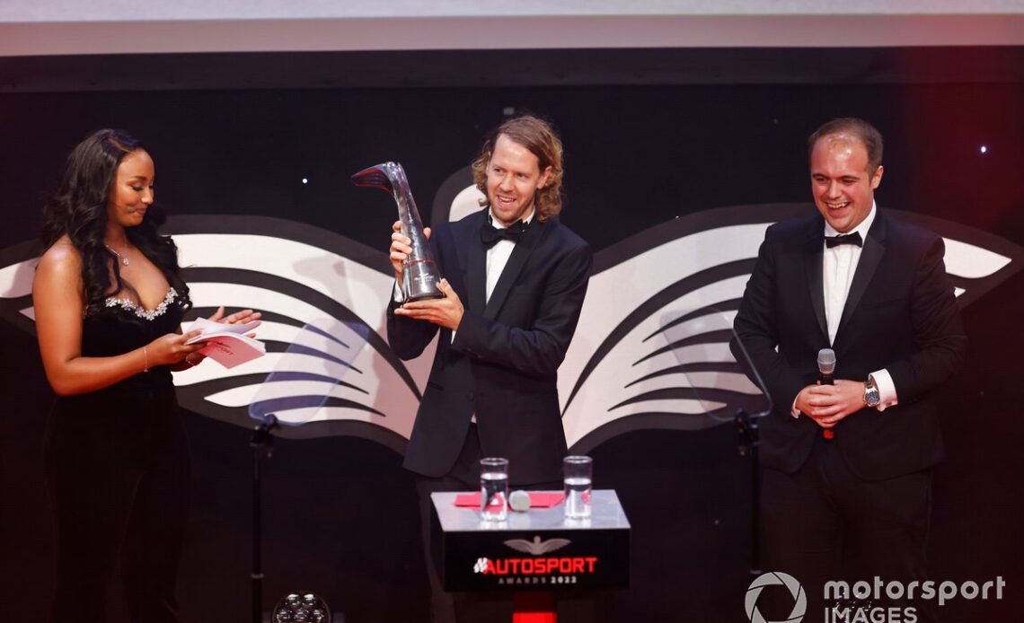 Sebastian Vettel on stage to accept a Lifetime Achievement Award from journalist Luke Smith alongside presenter Naomi Schiff