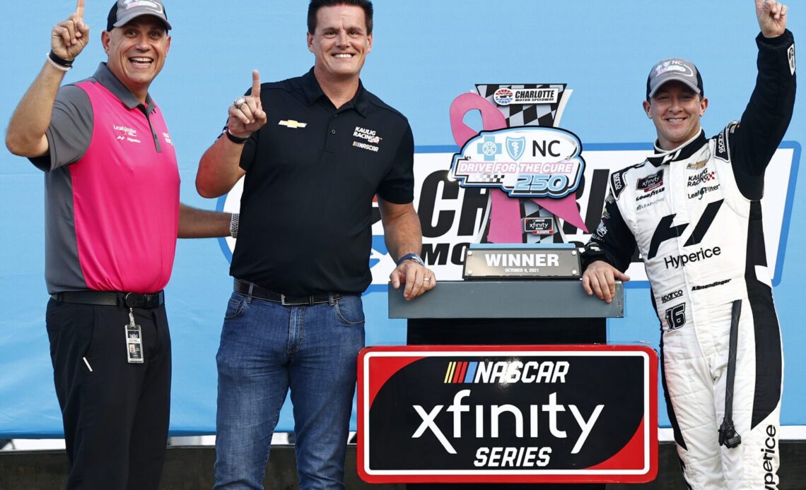 Chris Rice, President of Kaulig Racing, Matt Kaulig, owner of Kaulig Racing and AJ Allmendinger, driver of the #16 Hyperice Chevrolet, celebrate in victory lane after winning the NASCAR Xfinity Series Drive for the Cure 250 presented by Blue Cross Blue Shield of North Carolina at Charlotte Motor Speedway on October 09, 2021 in Concord, North Carolina. (Photo by Jared C. Tilton/Getty Images)