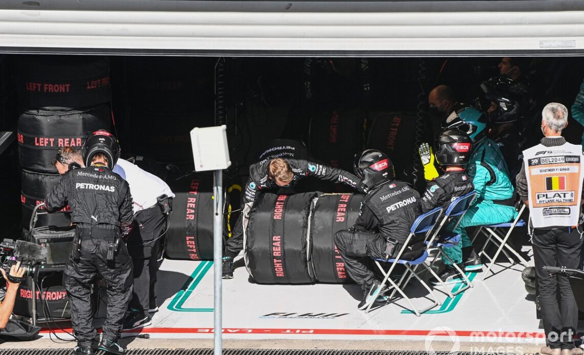 The Mercedes pit crew with tyres in warmers
